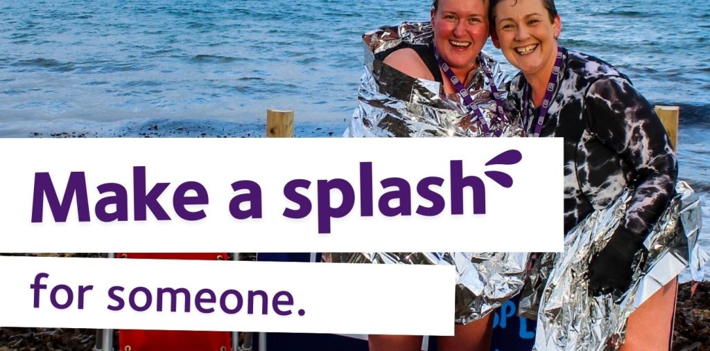 Two Festive Splash participants wearing foil blankets and hugging and smiling. Purple text reads Make a splash for someone.