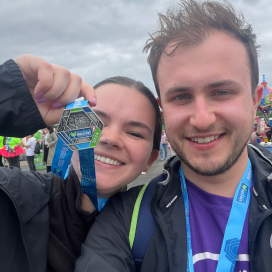 Curtis and his wife at the Belfast marathon finish line with their medals